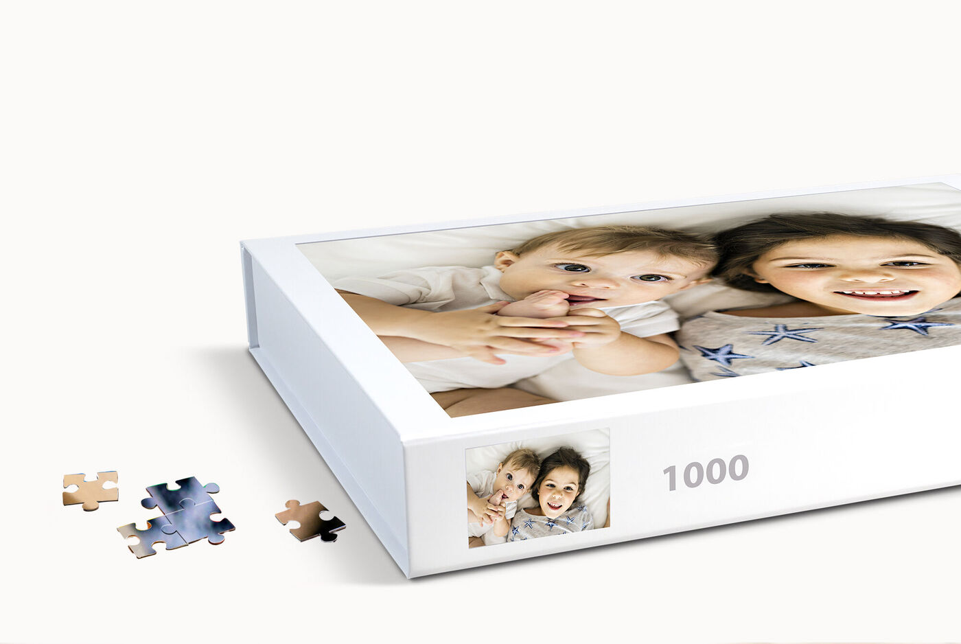 Un puzzle CEWE avec deux enfants sur l'emballage, maximum 1000 pièces.