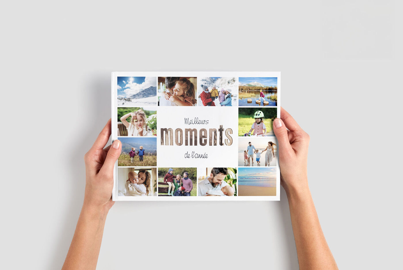 Une personne tient un album photo avec différentes photos de famille.